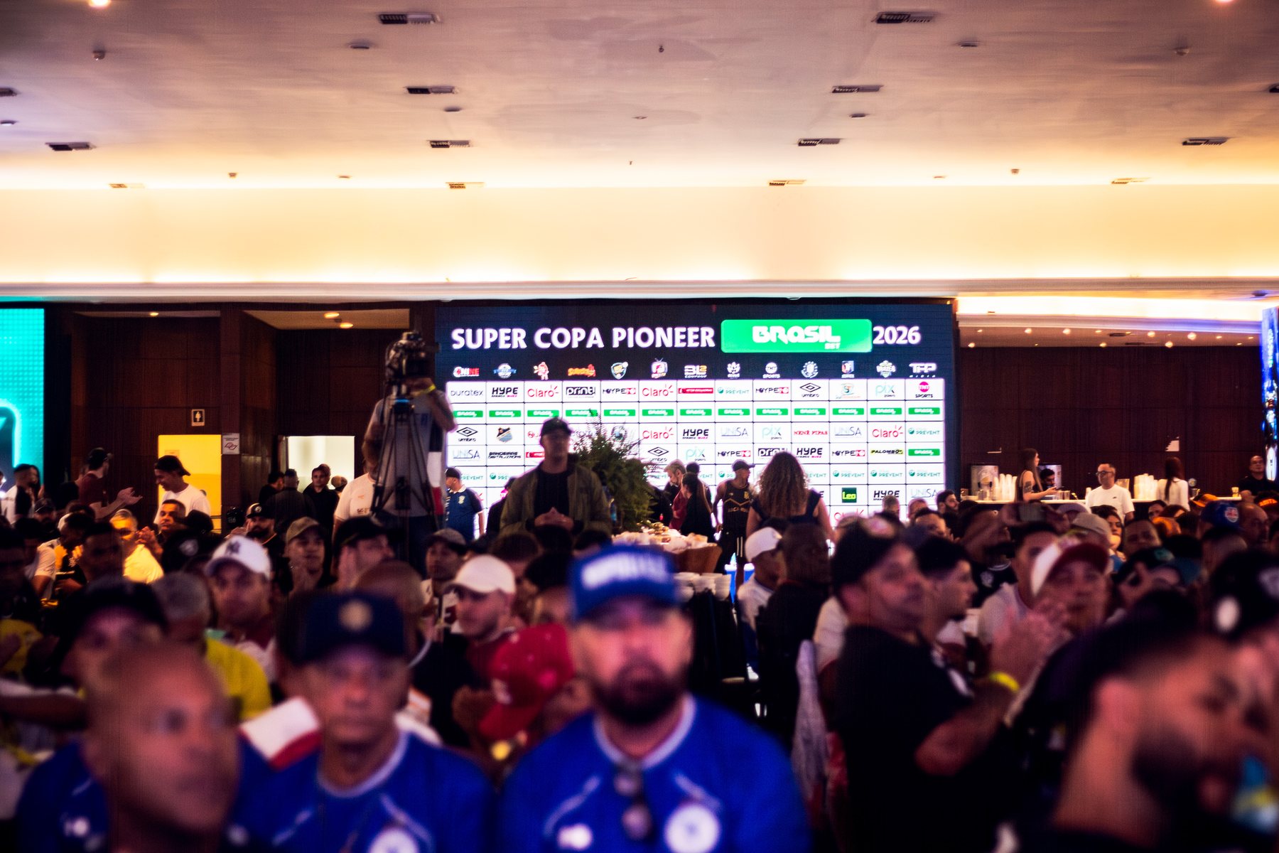 Registro fotográfico real da Super Copa Pioneer 2026 com a marca HYPE visível — Público e comunidade.